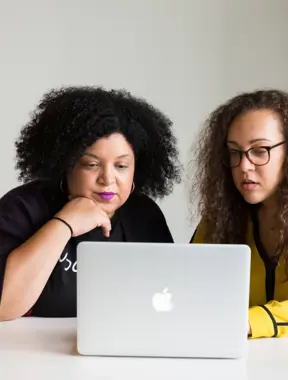 Two ladies working on a laptop